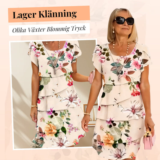 Kaskadklänning med blommönster och flera växter